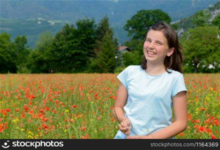 a young teenage girl in poppy field