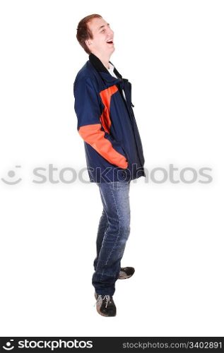 A young teenager in jeans and blue and orange jacket standing in thestudio and laughing, for white background isolated.