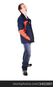 A young teenager in jeans and blue and orange jacket standing in thestudio and laughing, for white background isolated.