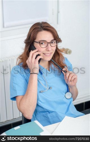 a young woman doctor talking on the phone