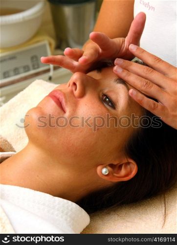 a young woman gets a facial massage at a spa hotel