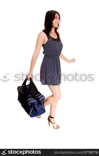 A young woman in a grey dress carrying a big bag in her hand, isolatedon white background.