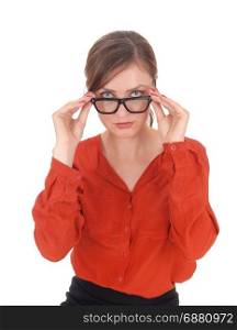 A young woman in a red blouse looking over her black frame glassesinto the camera, isolated for white background