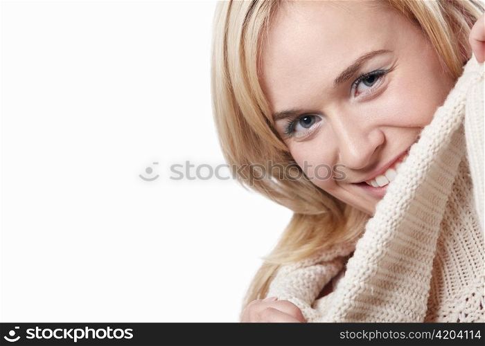 A young woman in a sweater isolated