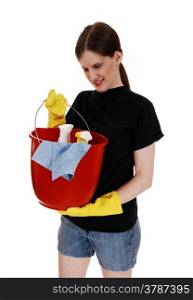 A young woman in shorts and yellow rubber cloves holding up an redbucket ready for cleaning, for white background.