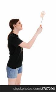 A young woman in shorts holding a paint roller to paint a wall,isolated on white background.