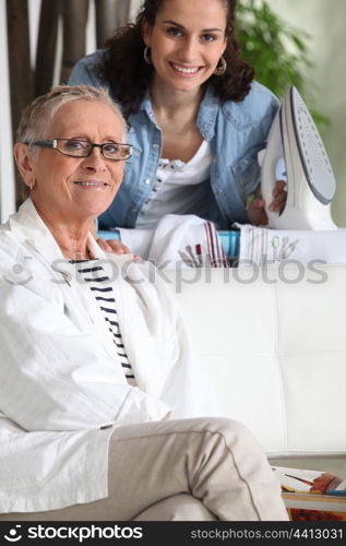 a young woman ironing and an older woman