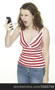 A young woman is annoyed and looks at the phone