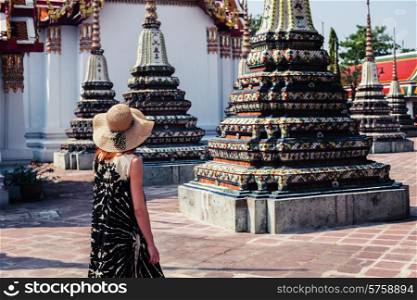 A young woman is exploring a buddhist temple