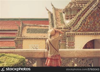 A young woman is exploring a palace in Thailand