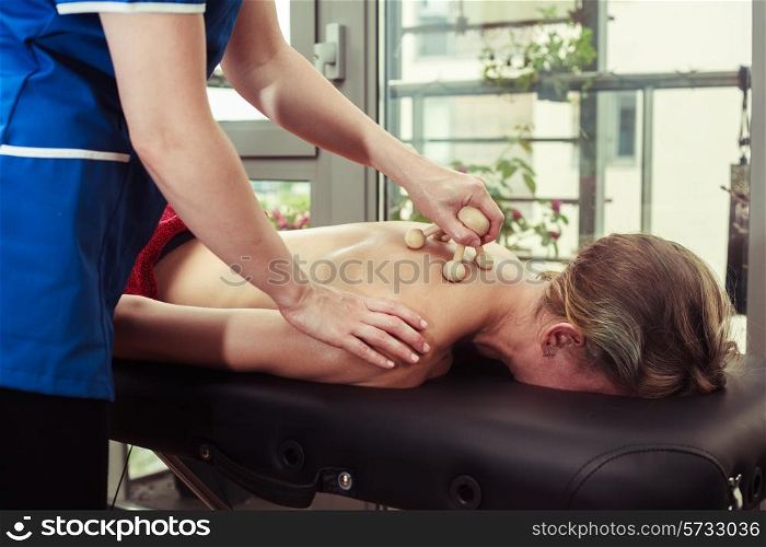 A young woman is getting a massage from a therapist
