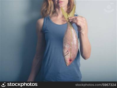 A young woman is holding an exotic Carribean snapper