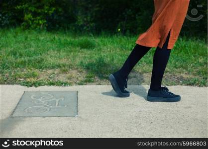A young woman is making an error and is walking on the bicycle path