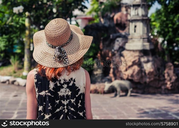 A young woman is relaxing in a buddhist temple garden