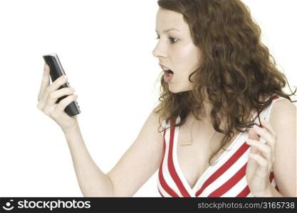 A young woman is shocked by a phone call