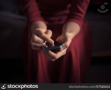 A young woman is using a smart phone at home