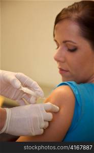 a young woman is vaccinated against the flu to a doctor