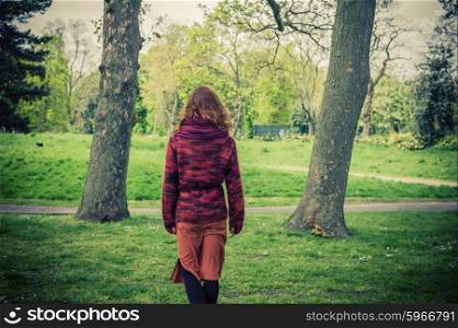 A young woman is walking in the park
