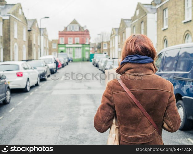 A young woman is walking in the street in winter