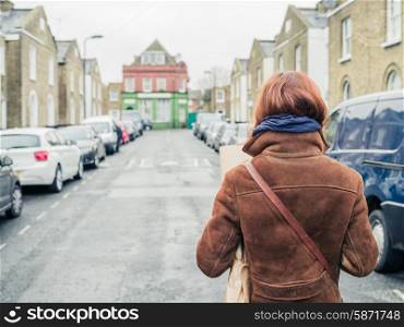 A young woman is walking in the street in winter