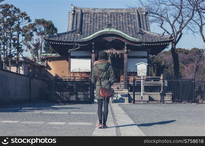 A young woman is walking in Ueno park in Tokyo