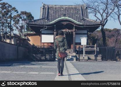 A young woman is walking in Ueno park in Tokyo