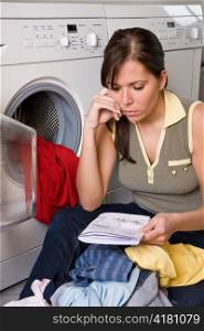 a young woman is washing day. washing clothes with washing machine