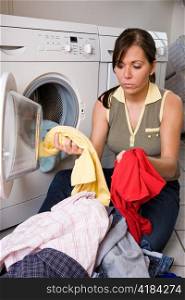 a young woman is washing day. washing clothes with washing machine