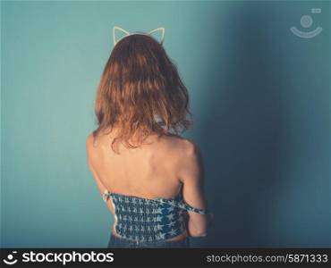 A young woman is wearing a hairband with cat ears
