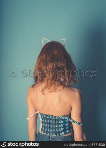 A young woman is wearing a hairband with cat ears