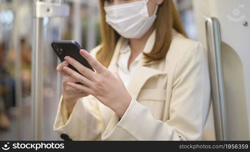 A young woman is wearing protective mask in metro , covid-19 protection , safety travel , new normal , social distancing , safety transportation , travel under pandemic concept. Young woman is wearing protective mask in metro , covid-19 protection , safety travel , new normal , social distancing , safety transportation , travel under pandemic concept