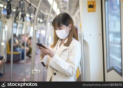 A young woman is wearing protective mask in metro , covid-19 protection , safety travel , new normal , social distancing , safety transportation , travel under pandemic concept. Young woman is wearing protective mask in metro , covid-19 protection , safety travel , new normal , social distancing , safety transportation , travel under pandemic concept
