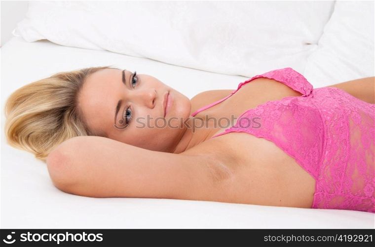 a young woman lies awake in bed. sleepless and thoughtful.