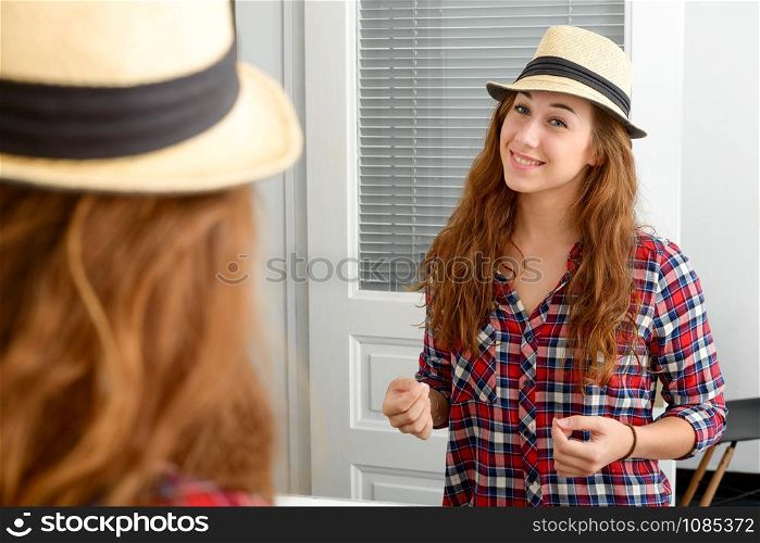 A young woman looking in a mirror