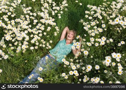 A young woman lying on grass