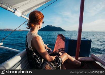 A young woman on a small boat is approaching a tropical island