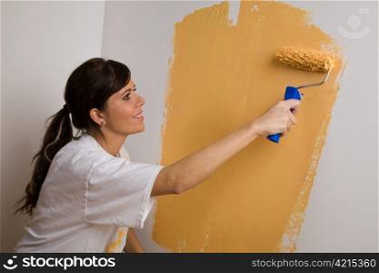 a young woman paints from her new apartment. color brings joy to life.