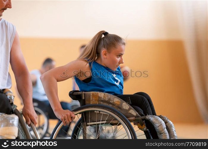 a young woman playing wheelchair basketball in a professional team. Gender equality, the concept of sports with disabilities. High quality photo. a young woman playing wheelchair basketball in a professional team. Gender equality, the concept of sports with disabilities.