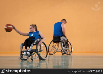 a young woman playing wheelchair basketball in a professional team. Gender equality, the concept of sports with disabilities. High quality photo. a young woman playing wheelchair basketball in a professional team. Gender equality, the concept of sports with disabilities.