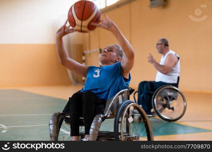 a young woman playing wheelchair basketball in a professional team. Gender equality, the concept of sports with disabilities. High quality photo. a young woman playing wheelchair basketball in a professional team. Gender equality, the concept of sports with disabilities. 