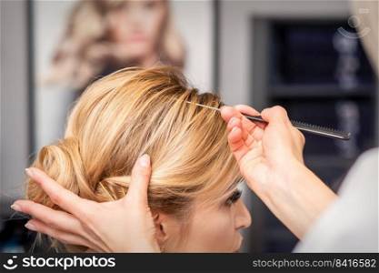 A young woman receiving her hair done in a beauty salon. Woman receiving her hair done