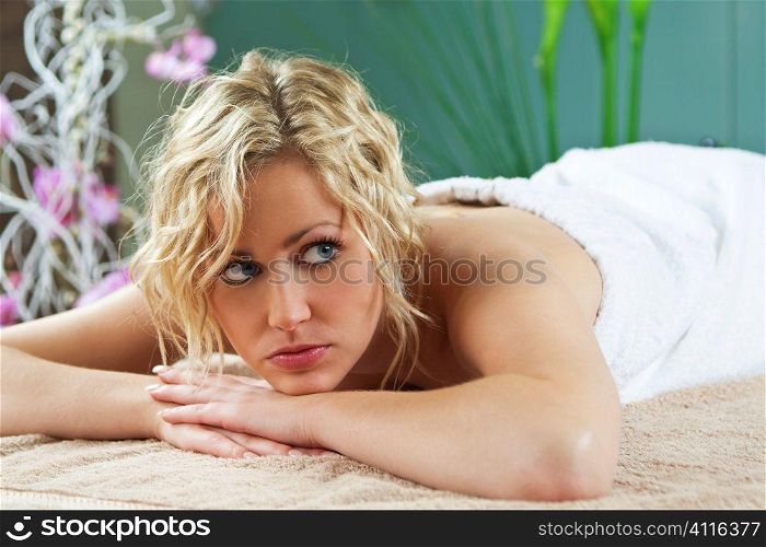 A young woman relaxing at a health spa waiting for her massage