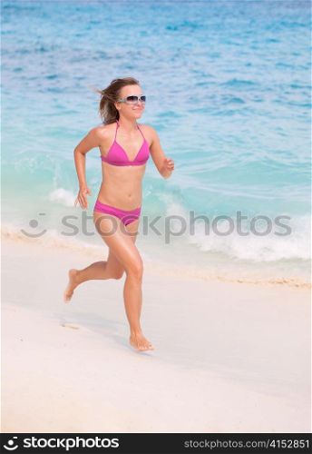 A Young Woman Runs Alone at the Beach