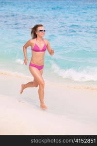 A Young Woman Runs Alone at the Beach