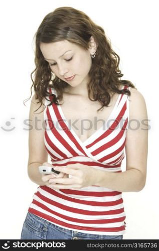 A young woman sends a text message from a cellphone