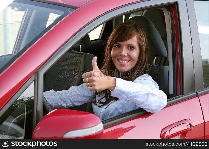 a young woman sits in her first car and is looking forward