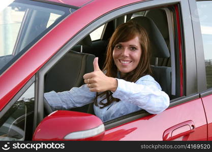 a young woman sits in her first car and is looking forward