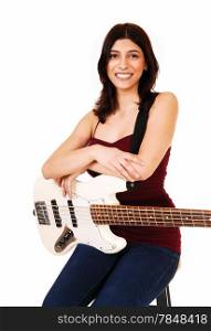 A young woman sitting on a chair, holding her guitar, isolated on whitebackground.