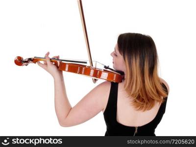 A young woman standing from the back in a close up image playing the violin with her blond hair, isolated for white background