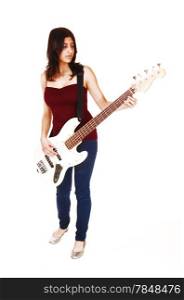 A young woman standing in the studio, playing her guitar, isolated on whitebackground.